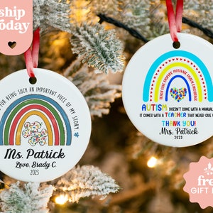 two personalized christmas ornaments hanging from a christmas tree