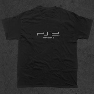 May include: Black t-shirt with a white PlayStation 2 logo and the text "PlayStation 2" printed on the front.