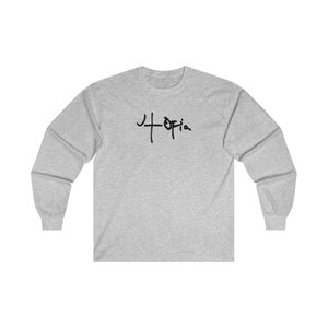 May include: A heather grey long-sleeve t-shirt with a black graphic of the word "+Ofia" on the front.