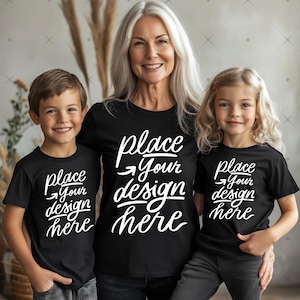 May include: Three people wearing black t-shirts with the text "place your design here" in white. The shirts are a mockup for a design project.