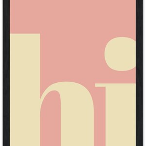 May include: A framed art print with a minimalist design. The artwork features the word "hi" in a cream-colored font against a pink background. The frame is black. The overall aesthetic is modern and simple.