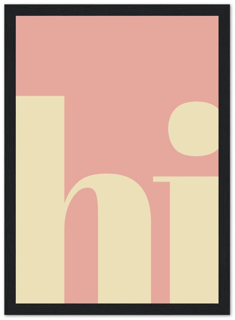 May include: A framed art print with a minimalist design. The artwork features the word "hi" in a cream-colored font against a pink background. The frame is black. The overall aesthetic is modern and simple.