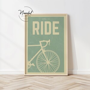 This DIGITAL DOWNLOAD bike poster features retro cycling art in soothing sage green tones, perfect wall art for cyclists, bike lovers, and vintage-inspired home decor.