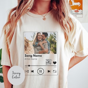 May include: A set of three ceramic mugs with a speckled, matte finish. The mugs are in shades of cream, light gray, and dark gray. Each mug has a simple, minimalist design and a rounded handle.