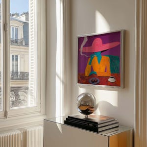 May include: A framed painting of a woman wearing a pink hat and a yellow jacket, sitting at a table with a cup of coffee and a plate of pastries. The painting is set against a purple background with a green chair and a white smoke plume.