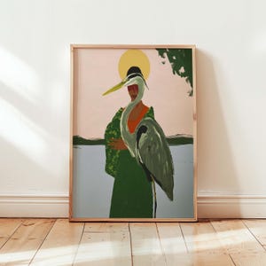 May include: A framed art print featuring a person with a heron. The person is wearing a green robe with a floral pattern and a black hat. The background includes a pink sky, a yellow sun, and a body of water.