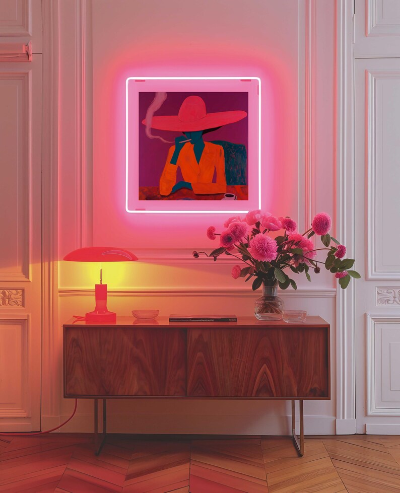 May include: A wooden cabinet with a red lamp on top and a vase of pink flowers. A neon sign with a woman wearing a red hat and smoking is hanging on the wall above the cabinet.