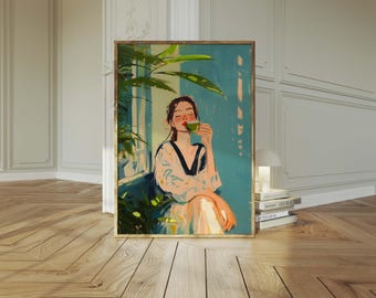 May include: A framed art print showing a person drinking from a green cup. The person is wearing a white and black patterned robe. The background is a light blue wall with green plants. The artwork has a warm, inviting aesthetic.