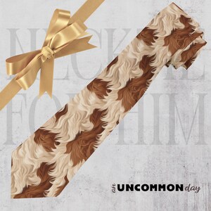 May include: A patterned necktie with a brown and cream wavy design. The tie is angled across the image, with a gold ribbon and bow in the upper left corner. The words "an UNCOMMON day" are printed in black.