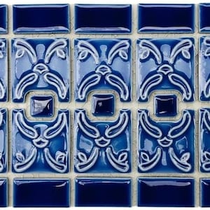 May include: A sheet of blue ceramic tile with a white floral pattern. The tiles are arranged in a repeating pattern.