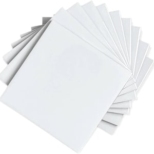 May include: A stack of ten white square canvas panels, perfect for painting or crafting.