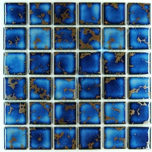 May include: A sheet of blue ceramic mosaic tiles with a gold metallic glaze. The tiles are arranged in a grid pattern.