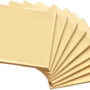 May include: A stack of ten cream-colored square sheets of paper.