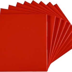 May include: A stack of ten red square canvases, fanned out to show the front of each canvas.