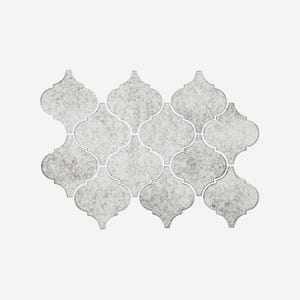 May include: A mosaic tile pattern in a neutral color palette. The tiles are a light gray with a speckled texture, arranged in a repeating quatrefoil design. The grout lines are a lighter shade of gray, creating a subtle contrast.