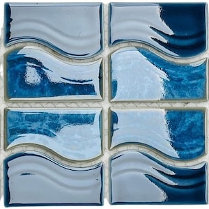 May include: A sheet of blue and white ceramic mosaic tiles with a wavy design. The tiles are arranged in a grid pattern.