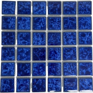 May include: A sheet of blue mosaic tiles with a white grout. Each tile has a unique swirling pattern.