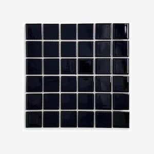 May include: A square mosaic tile sheet composed of small, glossy, black square tiles. The tiles are arranged in a grid pattern with thin white grout lines separating them. The tiles have a reflective surface.