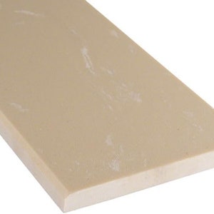 May include: A close-up of a light beige rectangular tile with a slightly textured surface. The tile has a subtle marbled pattern with white streaks.