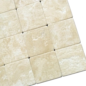 May include: A close-up of a beige travertine tile mosaic. The tiles are arranged in a staggered pattern, creating a textured surface.