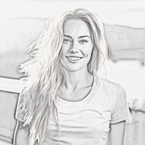 May include: A black and white pencil sketch of a woman with long blonde hair smiling. She is wearing a white t-shirt.