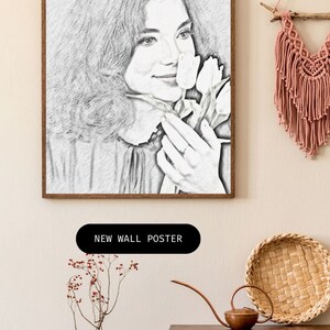 May include: A black and white pencil drawing of a woman holding a bouquet of white tulips. The drawing is framed in a wooden frame and is hanging on a wall.