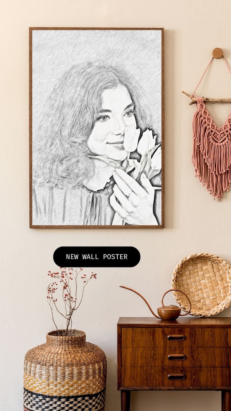 May include: A black and white pencil drawing of a woman holding a bouquet of white tulips. The drawing is framed in a wooden frame and is hanging on a wall.