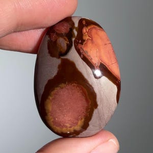 May include: A set of three ceramic mugs with a speckled, matte finish in cream, light grey, and dark grey. Each mug has a simple, modern design and a rounded handle.