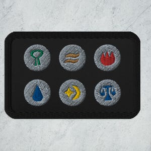 May include: A black fabric patch with six embroidered grey circles, each containing a different symbol. The symbols are a green tree, a wavy line, a red flame, a blue teardrop, a yellow star and crescent moon, and a blue scale.