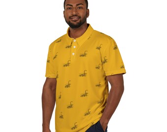 May include: A yellow short-sleeved polo shirt with a repeating pattern of black Nessie, the Loch Ness Monster, illustrations.