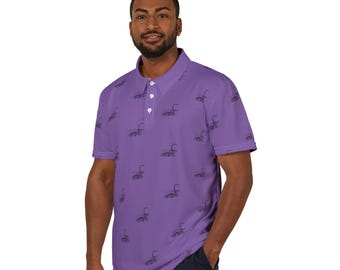 May include: A purple polo shirt with a black and white pattern of a mythical creature. The shirt has a button-up collar and short sleeves.