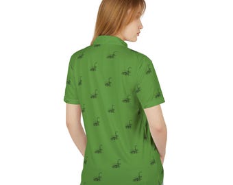 May include: A green short-sleeved polo shirt with a repeating pattern of black Loch Ness monsters.