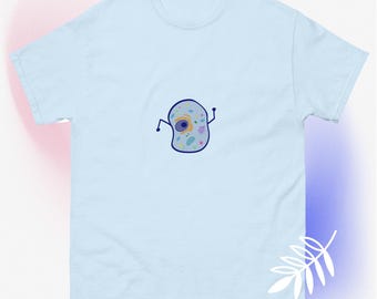May include: Light blue t-shirt with a cartoon illustration of a cell with a nucleus and other organelles. The cell has a blue outline and is filled with various colors, including pink, yellow, and green.