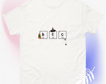 May include: White t-shirt with a graphic of the word "BOO" spelled out using chemical element symbols. The "O" for oxygen has a witch's hat on top and a spider hanging from it.