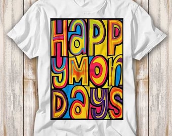 May include: White t-shirt with a colorful graphic that reads "Happy Mondays." The text is in a bold, playful font with a black border, featuring shades of yellow, blue, pink, and purple. The shirt is made of a soft material.