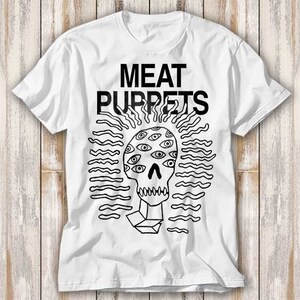 May include: White t-shirt with a black and white graphic of a skull with eyes and the text "MEAT PUPPETS".