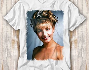 May include: White t-shirt with a printed image of a woman with blonde hair and a white veil. The image is in a rectangular frame with a distressed look.