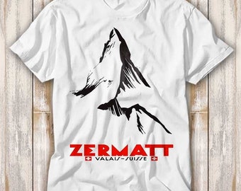 May include: White t-shirt with a black graphic of a mountain peak and the text "ZERMATT VALAIS-SUISSE" in red.