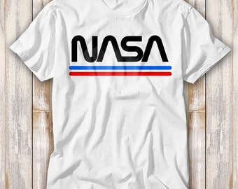 May include: White t-shirt with a black NASA logo and red and blue stripes.