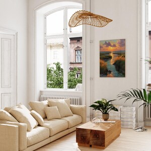 A modern living room with a large window overlooking a cityscape, featuring a beige sofa, a wooden coffee table, and a hanging woven light fixture.