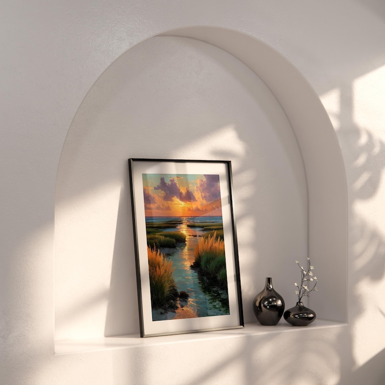 a framed painting of a sunset landscape, placed on a shelf next to two small vases.