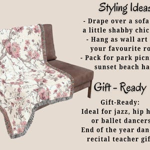 May include: A floral throw blanket draped over a brown chair. The blanket has a white background with pink flowers and grey branches. The blanket has a fringed edge. Text on the image reads "Styling Ideas" and "Gift-Ready".