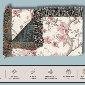 May include: A rectangular woven throw blanket featuring a floral design in pink and brown on a cream backdrop. The blanket has a fringed edge and a section with a geometric pattern. The image text reads "100% Cotton", "Woven Not Printed", "Soft & Comfy", "Breathable & Lightweight", "Meaningful Gift", and "Machine Washable".