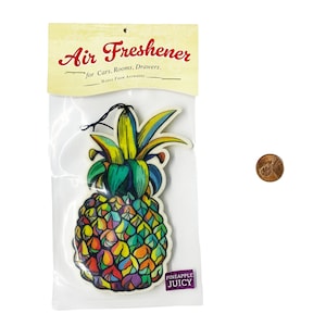 May include: A colorful pineapple air freshener with the text "Air Freshener for Cars, Rooms, Drawers. Hangs From Anywhere" and "Pineapple Juicy" on the packaging.