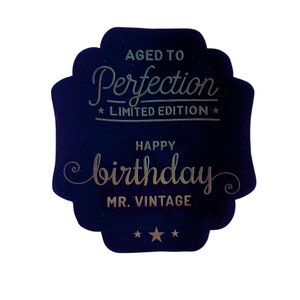 May include: A dark blue card with gold foil lettering that reads "Aged to Perfection - Limited Edition" and "Happy Birthday Mr. Vintage".