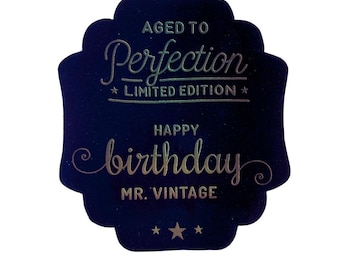 May include: A dark blue card with gold foil lettering that reads "Aged to Perfection - Limited Edition" and "Happy Birthday Mr. Vintage".