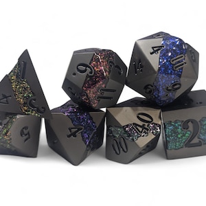 May include: Set of seven black metal dice with iridescent glitter embedded in the faces. The dice are numbered 1 through 6 and 4, 20, and 12.