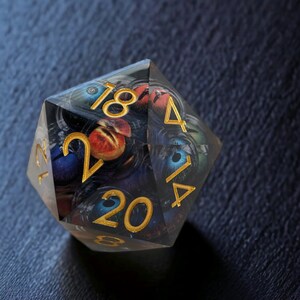 May include: A clear, multi-sided dice with gold numbers 1, 2, 4, 14, 18, 20, and a swirling, abstract design.