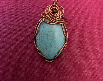 Turquoise and dark metal wire wrap pendant