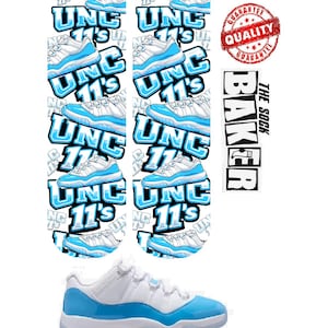 May include: White and light blue athletic shoe with a matching sock design featuring the text "UNC 11's". The image includes a "Quality Guarantee" stamp and the text "The Sock Baker".